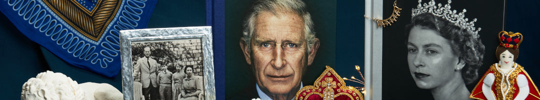 King charles iii and elizabeth ii hardback books against a blue backdrop.