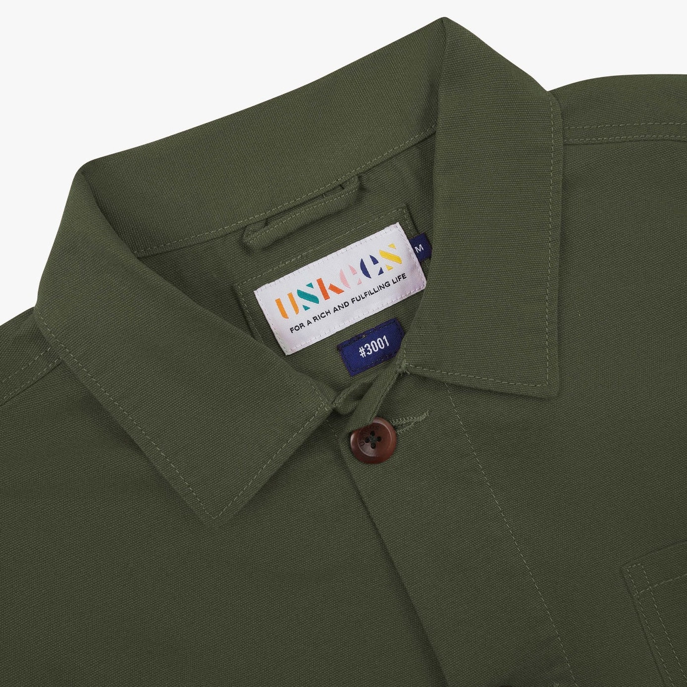 Close of detail of overshirt collar and button front. 