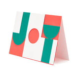 cut out graphic card saying 'joy' in red, green and white