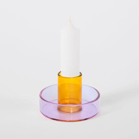 Glass candle holder with a lilac base and peach centre.