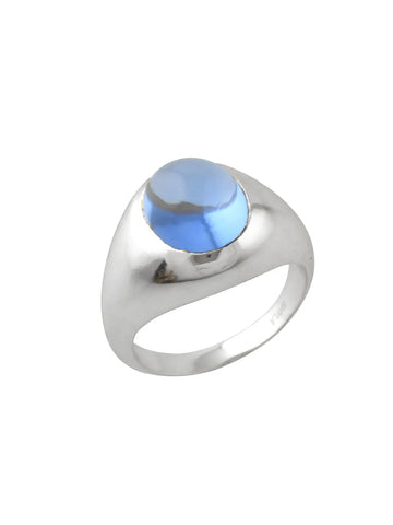 A chunky silver band ring with a single dark blue glass stone in the centre.