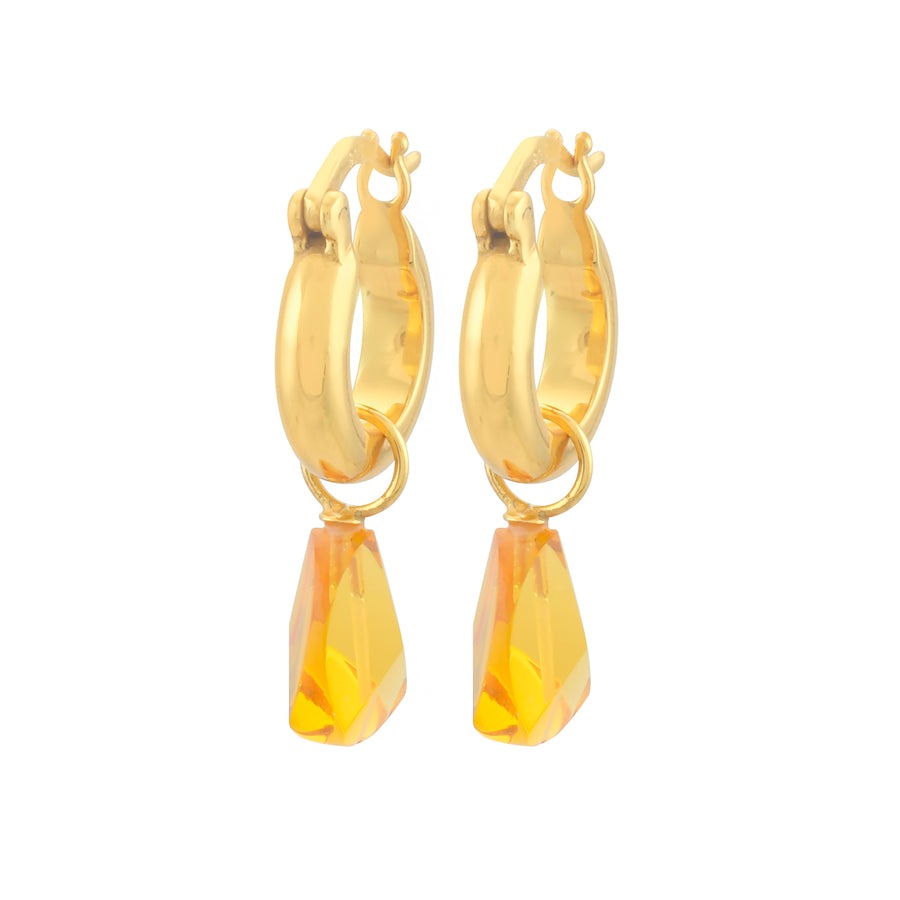 A pair of gold hoop earrings with a golden yellow gem hanging from each. 