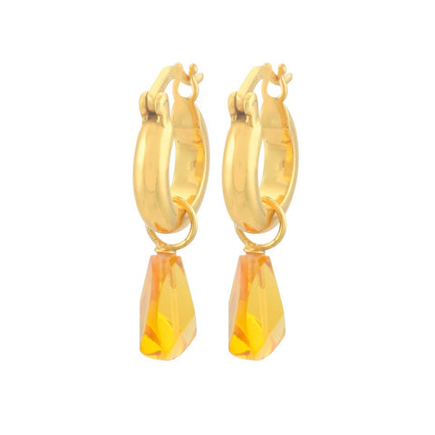 A pair of gold hoop earrings with a golden yellow gem hanging from each. 
