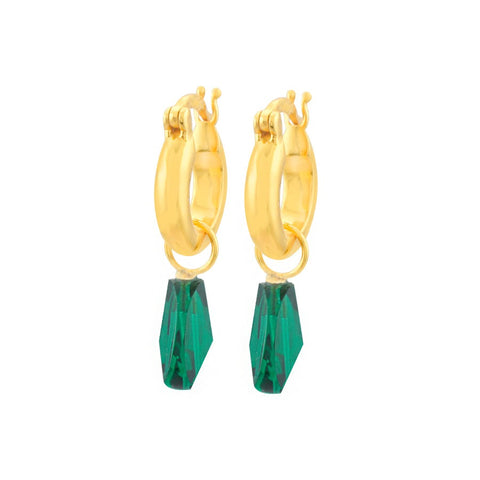 A pair of gold hoop earrings with an emerald green gem hanging from each. 