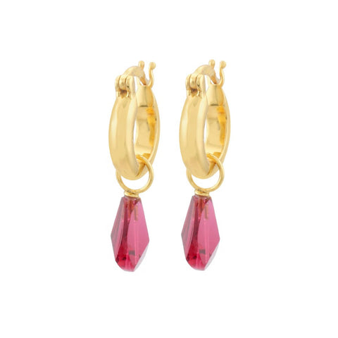 A pair of gold hoop earrings with a ruby gem charm hanging from each.