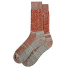 A pair of knitted socks in brown and neutral tones. 