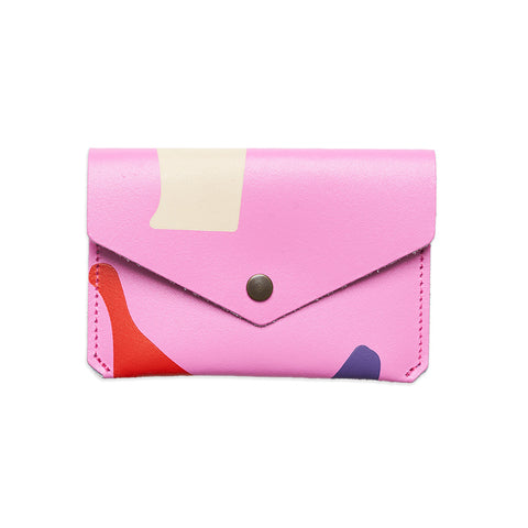 Rectangular leather hot pink purse with folded close and popper with colourful abstract designs.