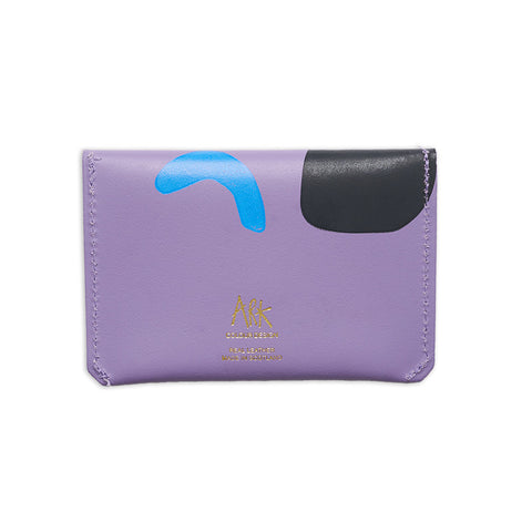 Back of rectangular leather purse in lilac with abstract designs and gold Ark logo.