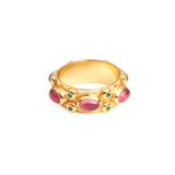 Front view of chunky gold ring with large ruby red stones and smaller emerald stones set in to the outer band.