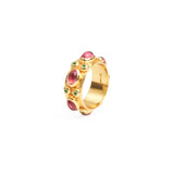 Side view of chunky gold ring with large ruby red stones and smaller emerald stones set in to the outer band.