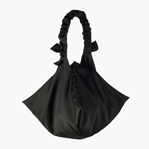 Geometric shaped black bag with scrunchie style handle.