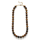 Necklace with brown beaded chain on a white background