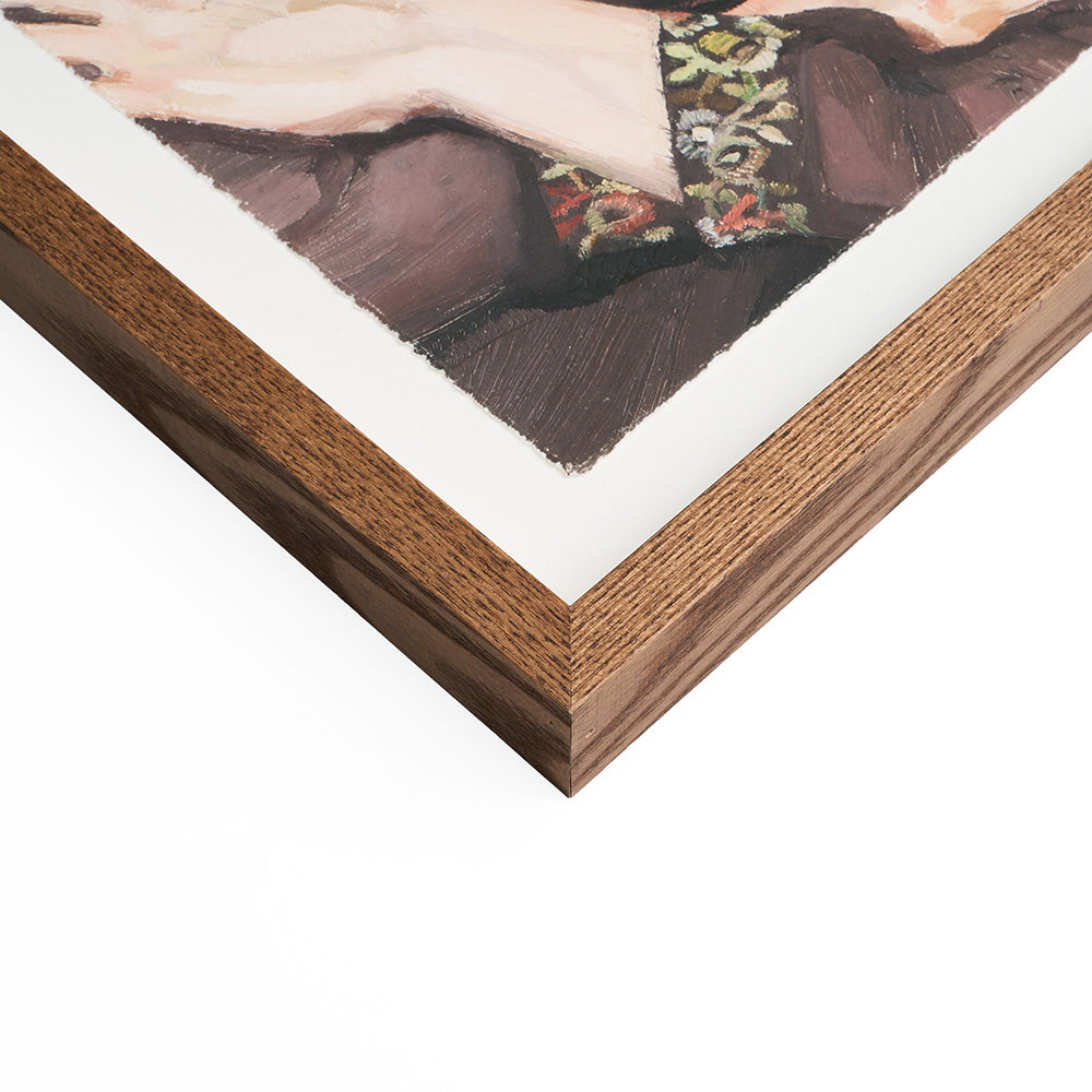 Close up of a wooden picture frame corner with a portion of a painting visible.