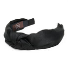 A black fabric headband with knot design against a while background.
