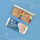 Set of Cotton Twist Bright Mix Watercolour Pencils in a tin on a blue background