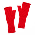 Pair of knitted red fingerless gloves on a white background