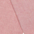 A close up view of the wool texture of a scarf in pale pink. 
