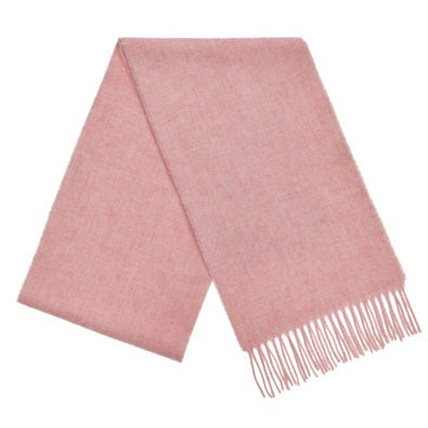 A folded wool scarf in soft pink colour with tassels at the end. 