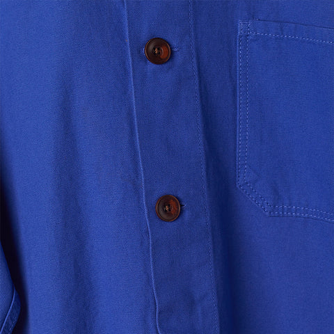 Close up of the brown buttons on the ultra blue buttoned overshirt.