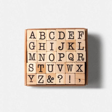 A set of 26 wooden stamps featuring capital letters and symbols.