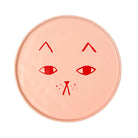 Round pink ceramic late with red cat face design on a white background