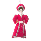 This decoration features a woman with dark brown hair and a long regal gown in magenta pink.