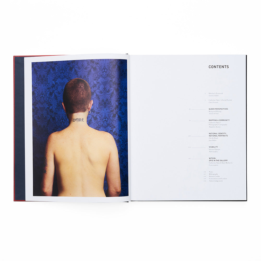 Open book showing a person with a tattoo on their back and a contents page.
