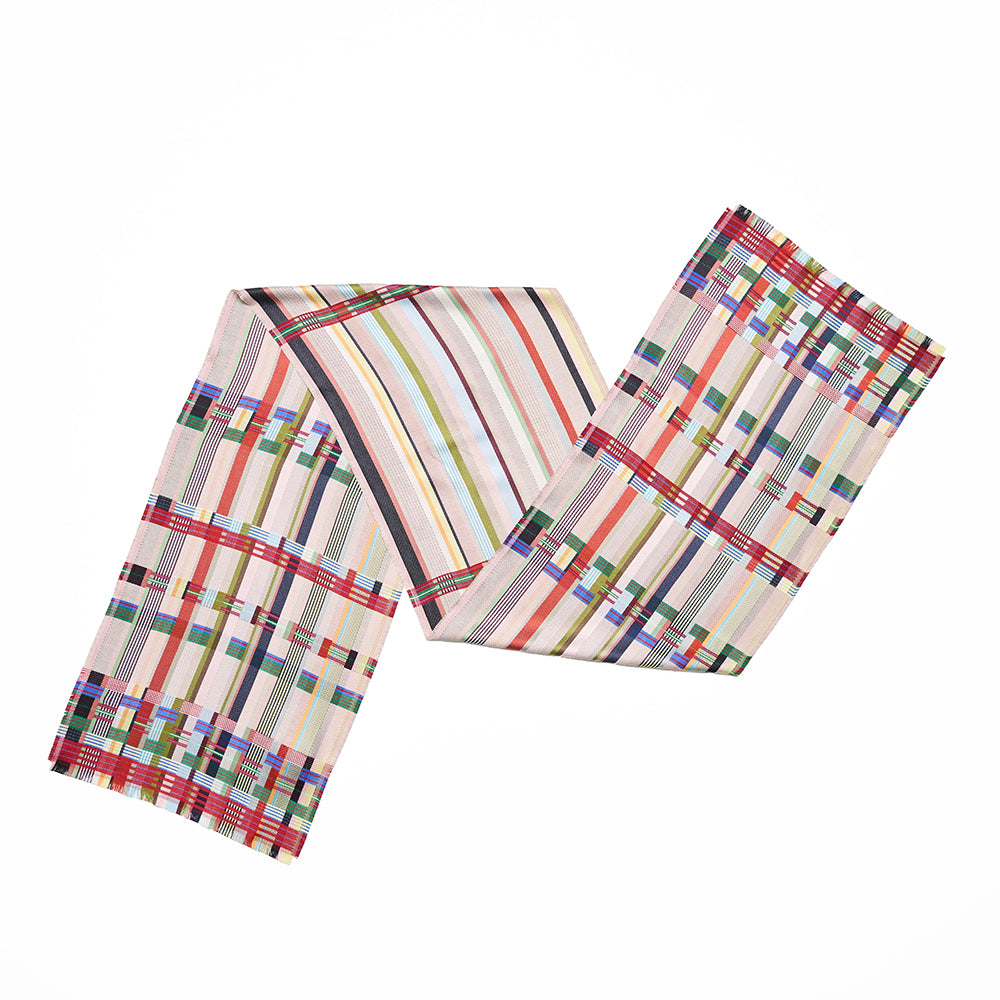 A multicoloured scarf with a geometric pattern of stripes and squares folded in a zig zag shape.