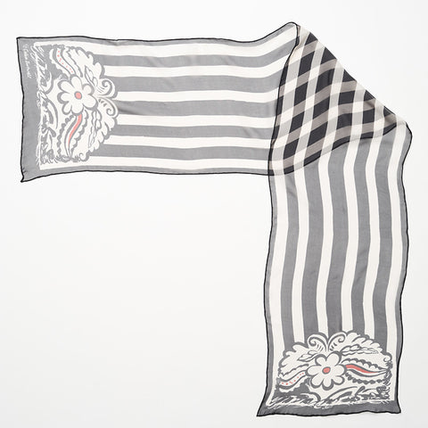 Above shot of black and white striped silk scarf with floral motif at both ends.