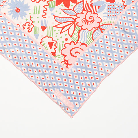 Celia Birtwell's signature printed on a scarf with a blue and red floral pattern.