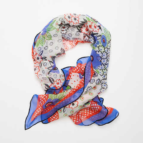Celia Birtwell styled scarf with a blue and red floral pattern and black edging.