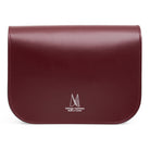 Reverse of maroon leather handbag with 'Village Leathers' logo on a white background