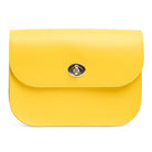 Yellow leather handbag with a silver clasp on a white background