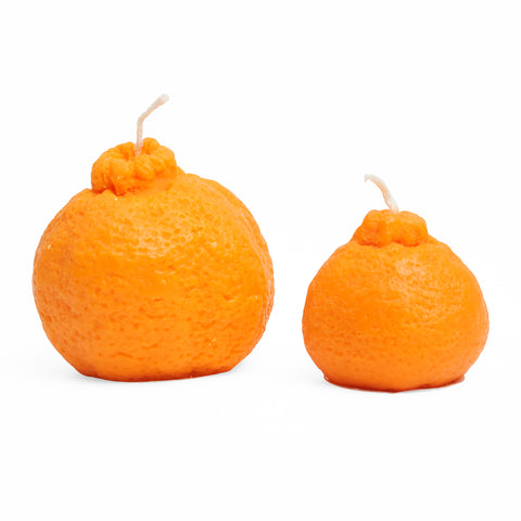 Medium and small, orange, clementine shaped candles side by side.