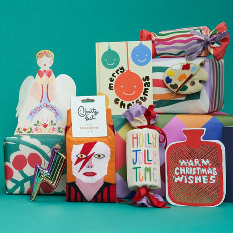 A collection of objects like colourful cards and wrapped presents and socks, all against a green background.