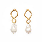 A pair of earrings each with a double golden figure of 8 shaped loop with a large pearl hanging below.