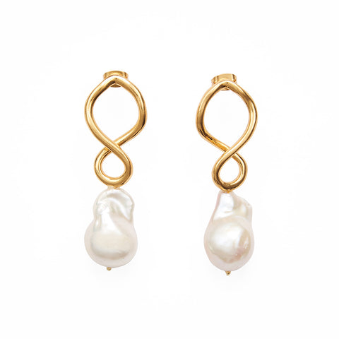 A pair of earrings each with a double golden figure of 8 shaped loop with a large pearl hanging below.