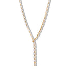Gold necklace with clear crystal rectangular stones on a white background
