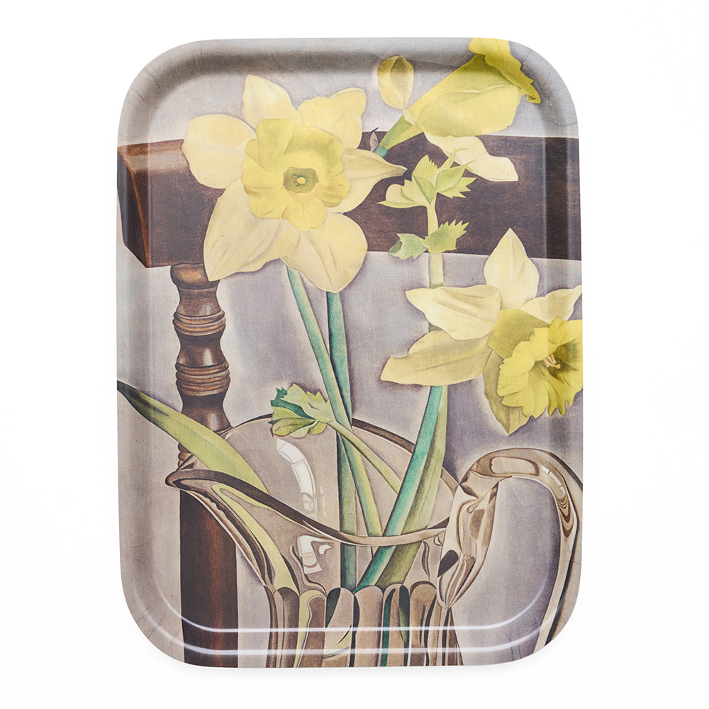 Decorative tray with floral design featuring yellow daffodils and a glass pitcher.