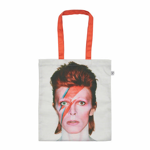 A white tote bag with red handles, featuring a photograph of David Bowie with lightning bolt makeup.