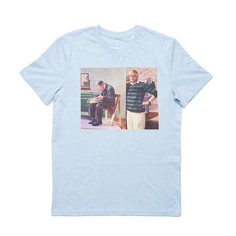 Pale blue t-shirt with round neck featuring a portrait of David Hockney in a green and black stripe top. 