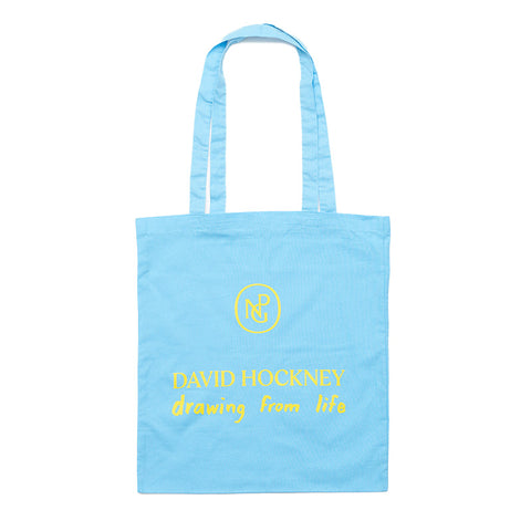 Bright blue tote bag with "David Hockney, drawing from life" and NPG logo in yellow print.