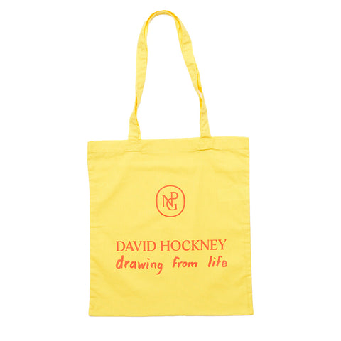 Bright yellow tote bag with "David Hockney, drawing from life" and NPG logo in red print.