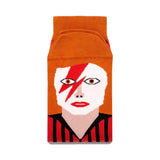 Front view of a pair of socks with a colour block illustration of David Bowie and lightning bolt makeup.