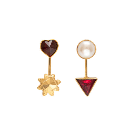 Mismatched stud drop earrings. One with a red heart charm and a gold sun below and one with a pearl stud and a red triangle below.