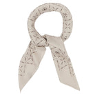 Tied beige scarf with grey diamond pattern on a white background