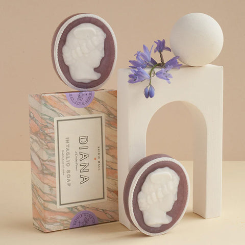 Set of two purple oval soaps with outline of goddess diana cameo in white. 