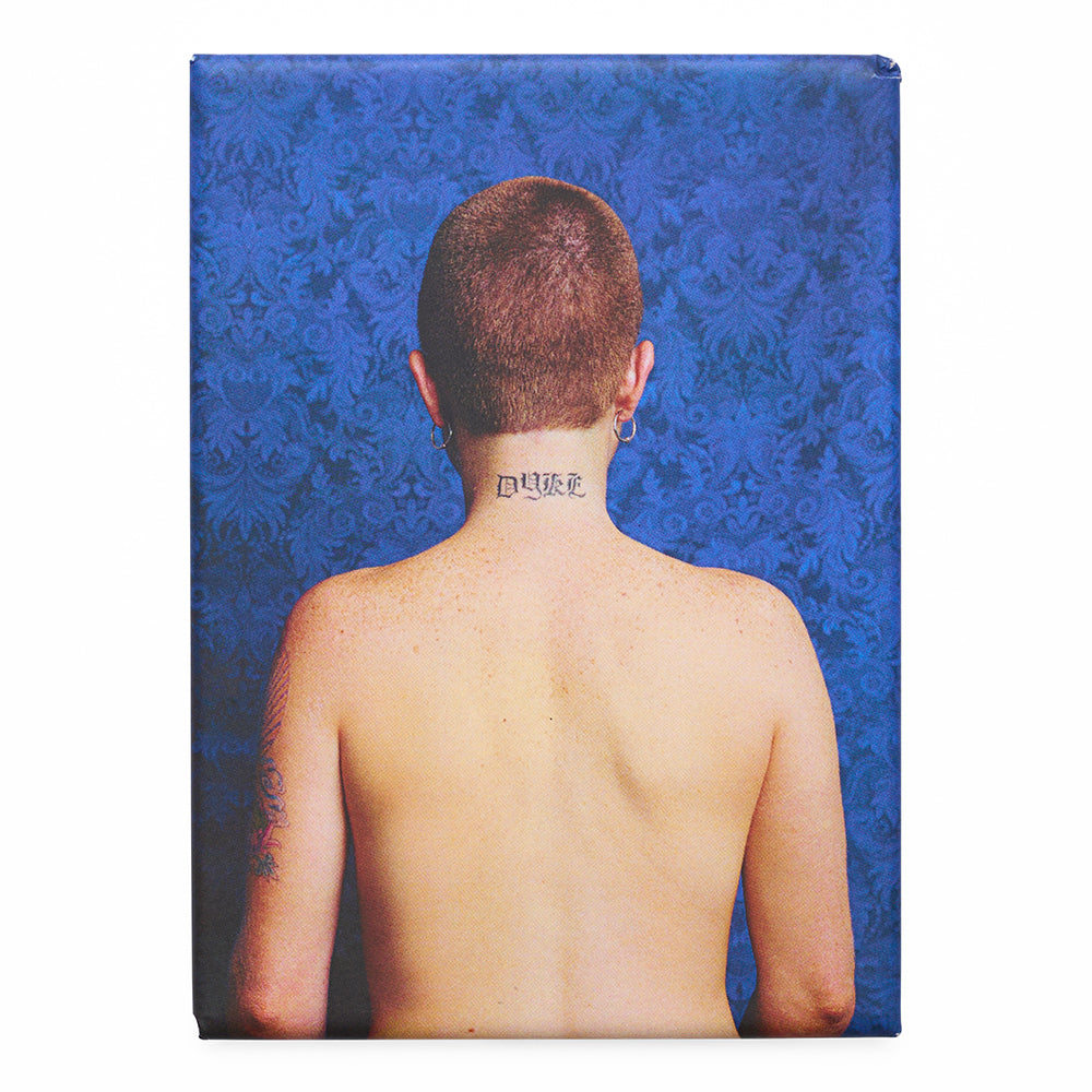Magnet with a photograph of a person's back with a tattoo against a blue floral patterned background
