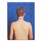 Magnet with a photograph of a person's back with a tattoo against a blue floral patterned background