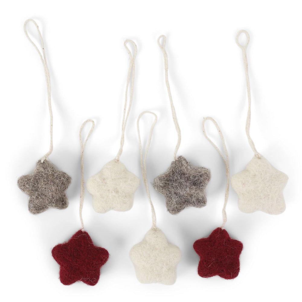 A set of seven star shaped felt decorations in a mix of cream, grey and red.